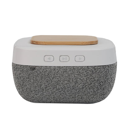 Bluetooth Speaker with Wireless Charging featuring fabric texture, play/pause and volume control buttons, and wooden charging pad on top