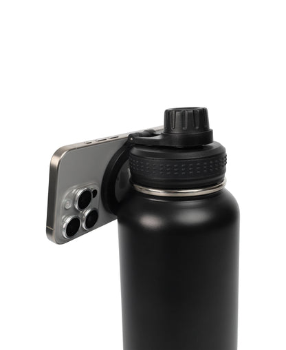 Magnetic Lid Stainless Steel Bottle in black with a phone magnetically attached to the lid, showing functionality and design.